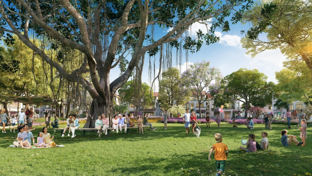 Công viên cây xanh rộng lớn với cây cổ thụ, thảm cỏ và khu sinh hoạt cộng đồng trong khu đô thị của **Sun Group tại Bắc Ninh.
